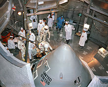 The Apollo 1 crew, Gus Grissom, Ed White and Roger Chaffee, enter their spacecraft for a test in the O&C altitude chamber on October 18, 1966. Apollo 1 crew prepare to enter their spacecraft in the altitude chamber at Kennedy Space Center.jpg