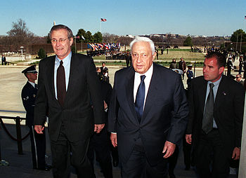 Secretary of Defense Donald H. Rumsfeld (left)...