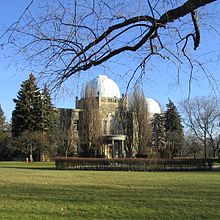 The administration building, with two of the observatory's telescopes built on top. The building's third dome is just out of sight behind the trees on the left. Dunlap Observatory Administration Building.jpg