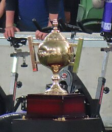 Image of a medium sized gold trophy on a wooden stand