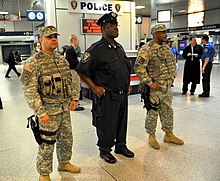 New York National Guard members and an Amtrak police officer at New York Penn Station in 2012 New York National Guard provides security on Anniversary of Bin Laden Death DVIDS570827.jpg