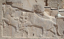 An ancient relief at Persepolis for Nowruz: eternal combat between the bull, representing the Moon, and the lion, representing the Sun and spring. Nowruz Zoroastrian.jpg