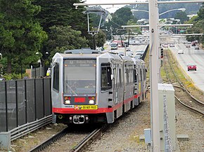 Outbound M Ocean View train arriving at SFSU, July 2017.JPG