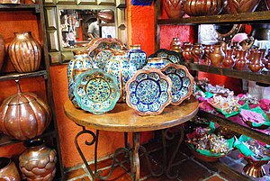 English: Painted copperwork vases and plates o...