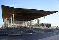 A glass building under a sail roof