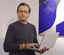 Sergio Maltagliati in 2016 with Romano Rizzato paintings