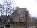 A view of the side of building including one of the double chimneys.