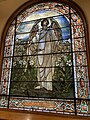 Stained glass window of angel on east side of sanctuary with folded glass