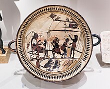 Arcesilaus II oversees the weighing of silphium for export, on a Laconian kylix, ca. 565-560 BC. Arkesilas Painter - Arkesilas supervising the silphion trade - Paris BnF CabMed 189 - 02.jpg