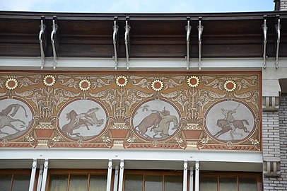 Sgraffito medallions at the top of the façade