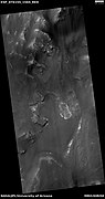 Wide view of layers in a crater and light-toned material, as seen by HiRISE under HiWish program. Light-toned materials often contain water bearing minerals like sulfates.