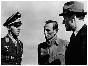 The head and shoulders of a man, shown in semi-profile. He wears a military uniform with various military decorations and an Iron Cross at the front of his shirt collar.