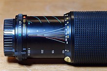 Minolta 100-300 zoom lens. The depth of field, and thus hyperfocal distance, changes with the focal length as well as the f-stop. This lens is set to the hyperfocal distance for
f/32 at a focal length of 100 mm. Minolta 100-300 at hyperfocal distance.jpg
