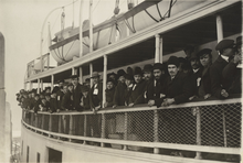 Immigrants on a ferry, c. 1910s Photograph of Immigrants on a Ferry Boat Near Ellis Island.png