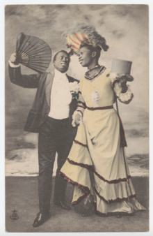 This 1908 photo was taken to promote the New Circus show "Joyeux Negres", filmed by Louis Lumiere. It belongs to the <<Postcard of female and male impersonators and transvestites>> from the Cornell University Library's Division of Rare and Manuscript Collections. Postcard of black female and male impersonators and cross-dressing.png