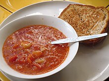 Vegetable soup and cheese sandwich, a meal which is suitable for vegetarians but not vegans Tomato soup and grilled cheese.JPG