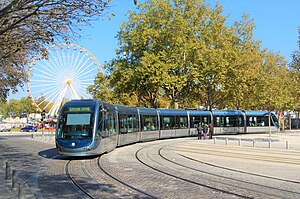 A TBM Line B tram torwards Pessac Centre running on the Place des Quinconces