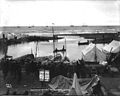 Boats and tents at the mouth of the Snake River in Nome, ca. 1900