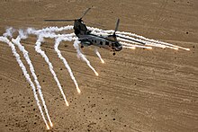 A CH-46E of VMM-268 deploying its onboard countermeasures during Operation Iraqi Freedom, 2008 CH-46 Sea Knight; Flares.jpg