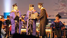Student receiving academic degree from Azim Premji during convocation, 2014. ISB Chairman Adi Godrej is in background. Graduation ceremony with Azim Premji.JPG