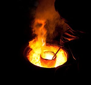 English: Melting metal in a ladle for casting ...