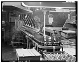 machinery with glassware on it and conveyer to oven