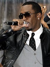 A picture of a man wearing sunglasses singing