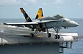 An F/A-18 Hornet taking off from the USS Kitty Hawk