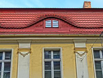 Pilasters and eyelid dormer on the mansard roof