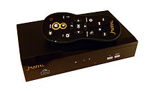 Some VOD services require the viewer to have a TV set-top box. This photo shows the set-top box for the Jazzbox VOD service and its accompanying remote control. Jazzbox.jpg