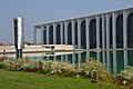 The "Colonna dai grandi fogli" sculpture by Arnaldo Pomodoro hanging over the reflective pool in front of the building