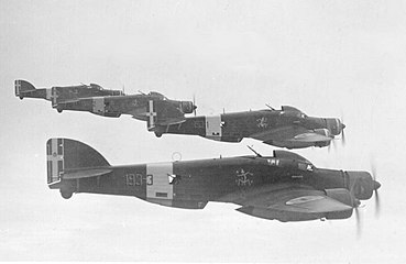 A flight of four Italian Savoia-Marchetti SM.79 Sparviero trimotor bombers, each with a similar gondola behind the bomb bay, but primarily used for the bombardier on this design, because of the nose-mounted engine taking up a bombardier's usual location