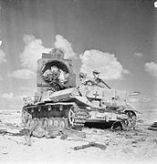 A destroyed Panzer IV with an armored N.K.A.V. painted with a Balkenkreuz.