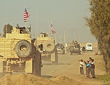 A convoy of U.S. soldiers during the American intervention in the Syrian civil war, December 2018 Us troops in syria.jpg