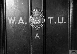 The entrance door to WATU. The crest was a relic from the destroyer HMS Tactician, decommissioned in 1931. Western Approaches Tactical Unit door.jpg