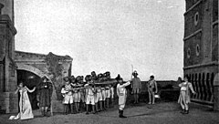 The execution of Cavaradossi at the end of act 3. Soldiers fire, as Tosca looks away. Photograph of a pre-1914 production by the Metropolitan Opera Puccini - Tosca - The execution of Cavaradossi - The Victrola book of the opera.jpg