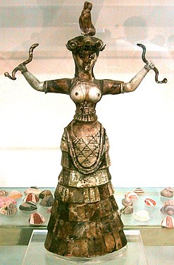 «Օձերի աստվածուհին»: Արձանիկ՝ Կնոսոսից: Մ.թ.ա.17-րդ դար: Կրում է զանգականման, ծալքավոր կիսարջազգեստ: