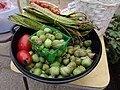 The red things in the bowl are tomatoes, the rest are different kinds of beans