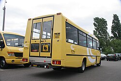 A special-needs school bus in London, England. Wheelchair ramp is below door.