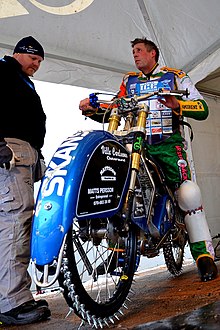 Man sitting on his Ice speedway motorcycle during the 2013 FIM Team Ice Speedway Gladiators World Championship Final in Sanok, Poland