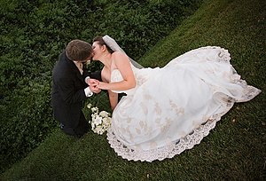A bride and a groom kiss.
