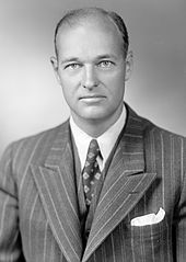 Head and shoulders portrait of a dignified man in his forties, wearing a suit and tie.