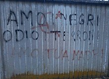 Racist graffiti in Caselette (Piedmont) saying amo i negri, odio i terroni
("I love negroes, I hate terroni") Graffito muro Caselette.jpg