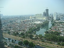 A view of Tanah Abang District centered on the Kebon Melati reservoir. The constructed high rise is the Grand Indonesia Hotel. The large green building in the distance is Tanah Abang market. Jakarta2.jpg