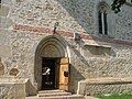 Portalul de intrare, pisania şi o fereastră în stil gotic