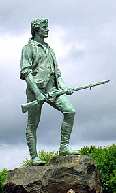 Statue du minuteman John Parker tenant un fusil dans ses mains.