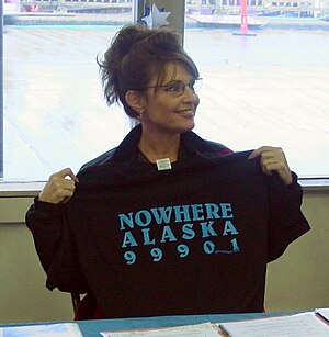Sarah Palin holding a T-shirt related to the G...