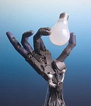 The Shadow robot hand system holding a lightbulb.