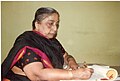 Dr.M.N.Singaramma writing at her desk