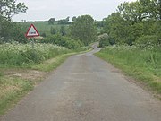 The road crosses a ford just north of Graby. This is an idylic view of the Lincolnshire countryside with the hedgerows and trees in full summer splendour and the Keck in bloom along the road verges.